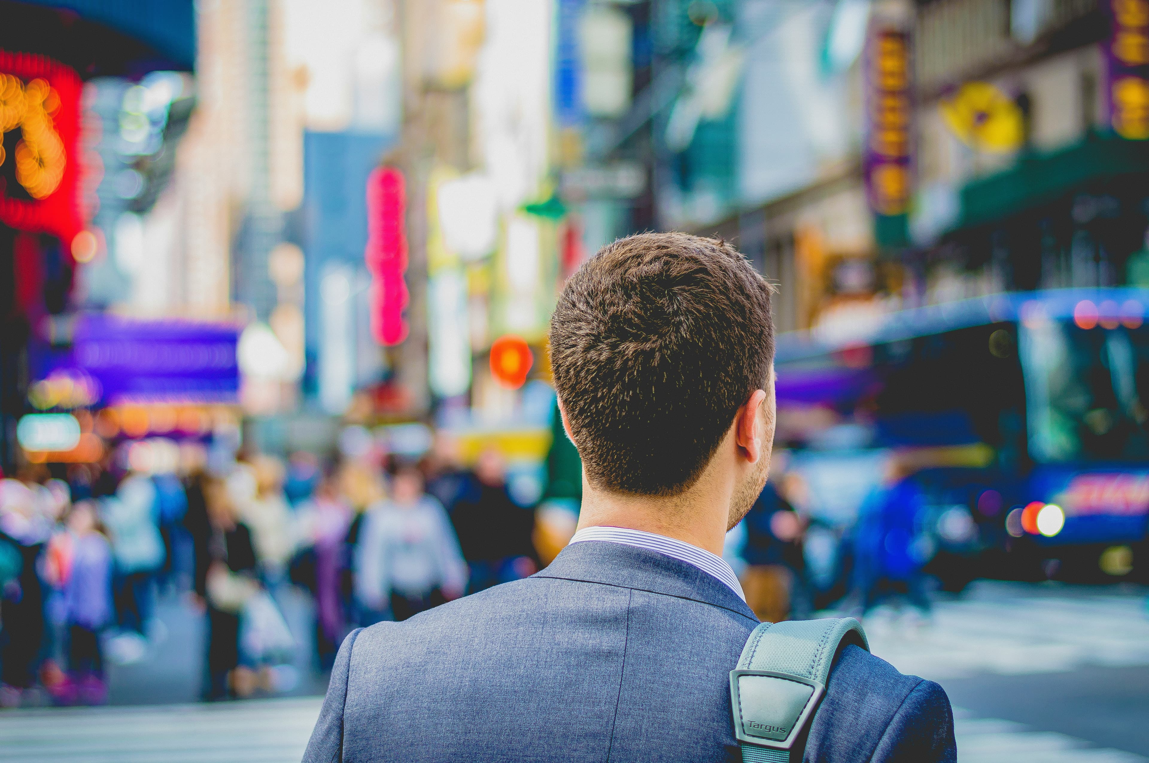 A young professional walking through a busy city street